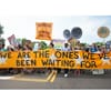 Picture of a demonstration with banner "We are the ones we've been waiting for."